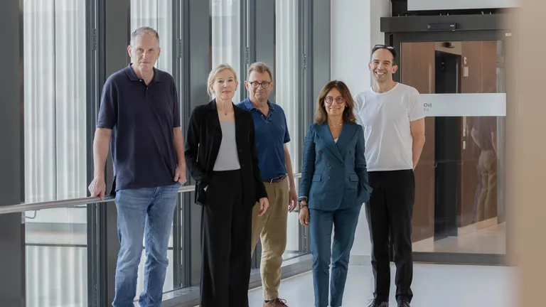 photo of five people standing in a hallway - Swiss network for dementia research team